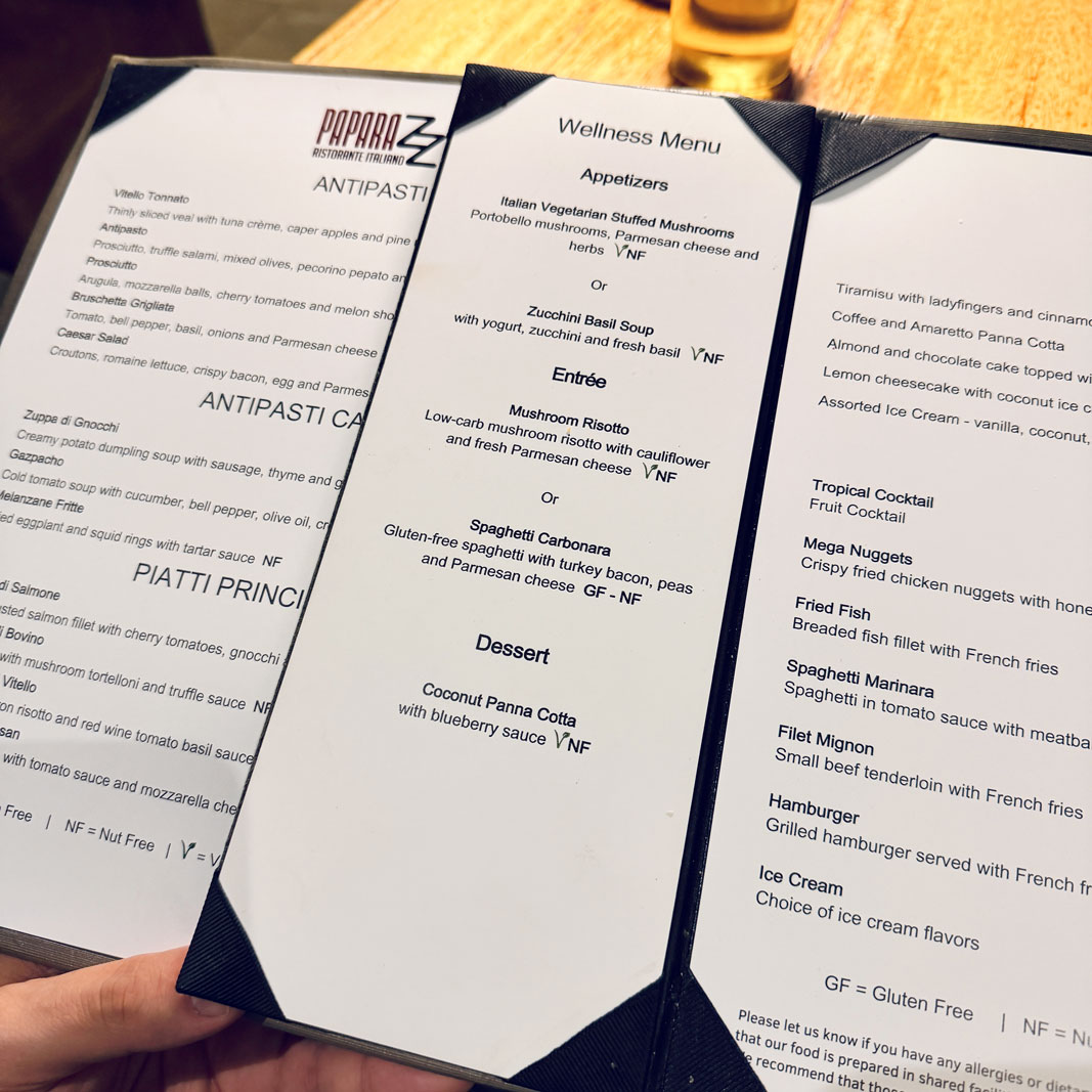 a hand holding a menu