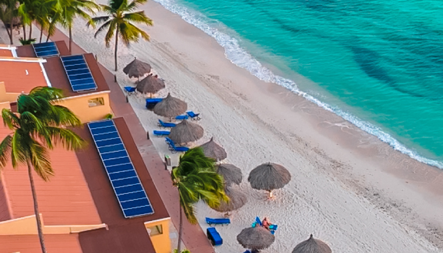 a beach with umbrellas and chairs and a building